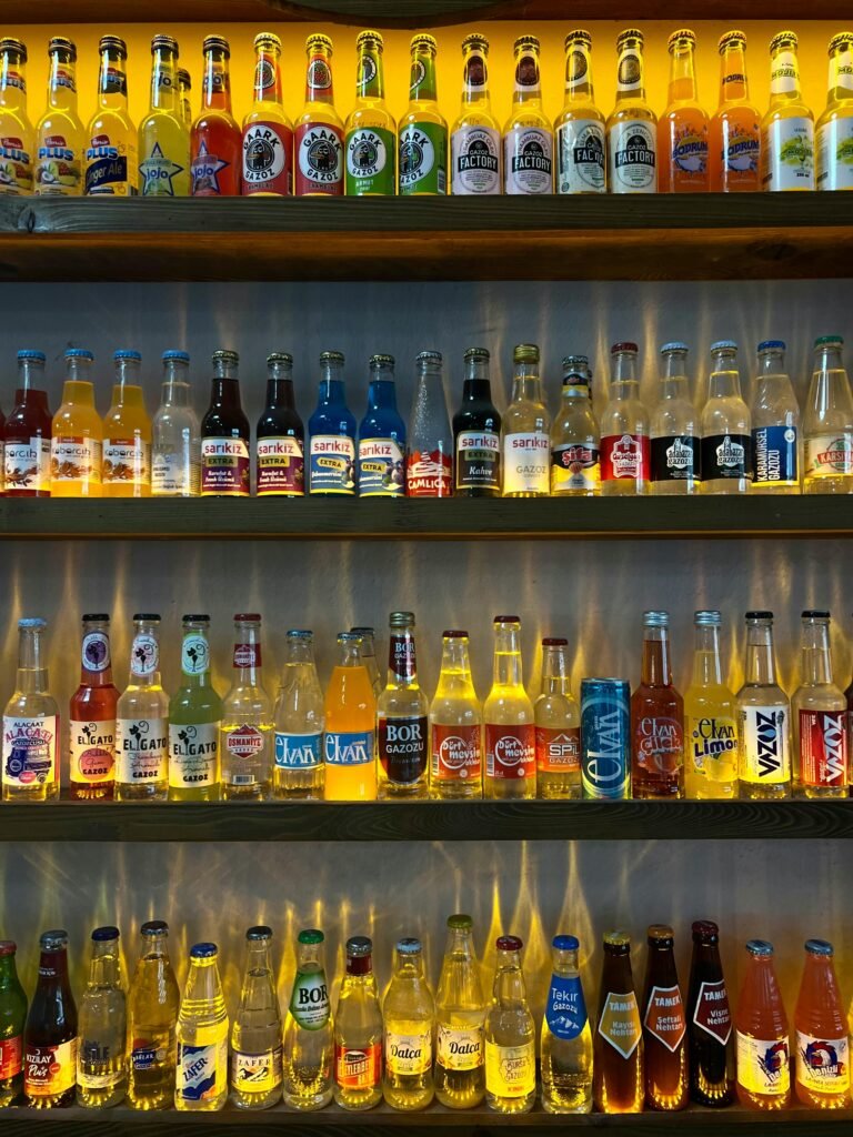 Vibrantly lit beverage display in Türkiye showcasing a variety of colorful bottled drinks.